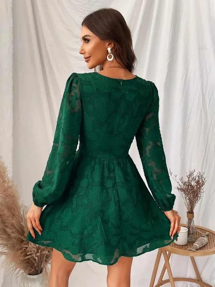 Vintage green lace dress with long sleeves and a deep V-neckline